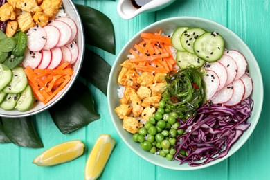 Photo of Delicious salad with chicken and vegetables on turquoise wooden table, flat lay