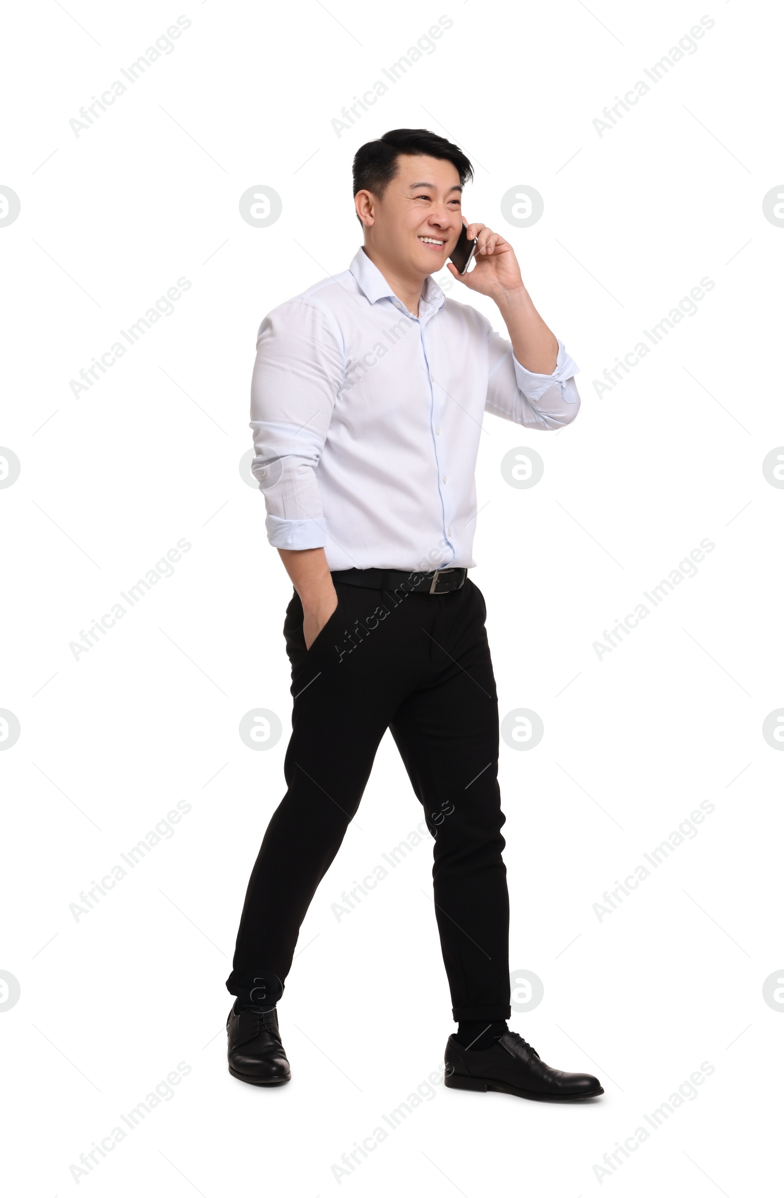 Photo of Businessman in formal clothes talking on phone against white background