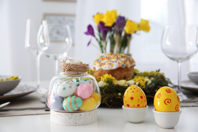 Photo of Festive Easter table setting with beautiful decorative eggs indoors