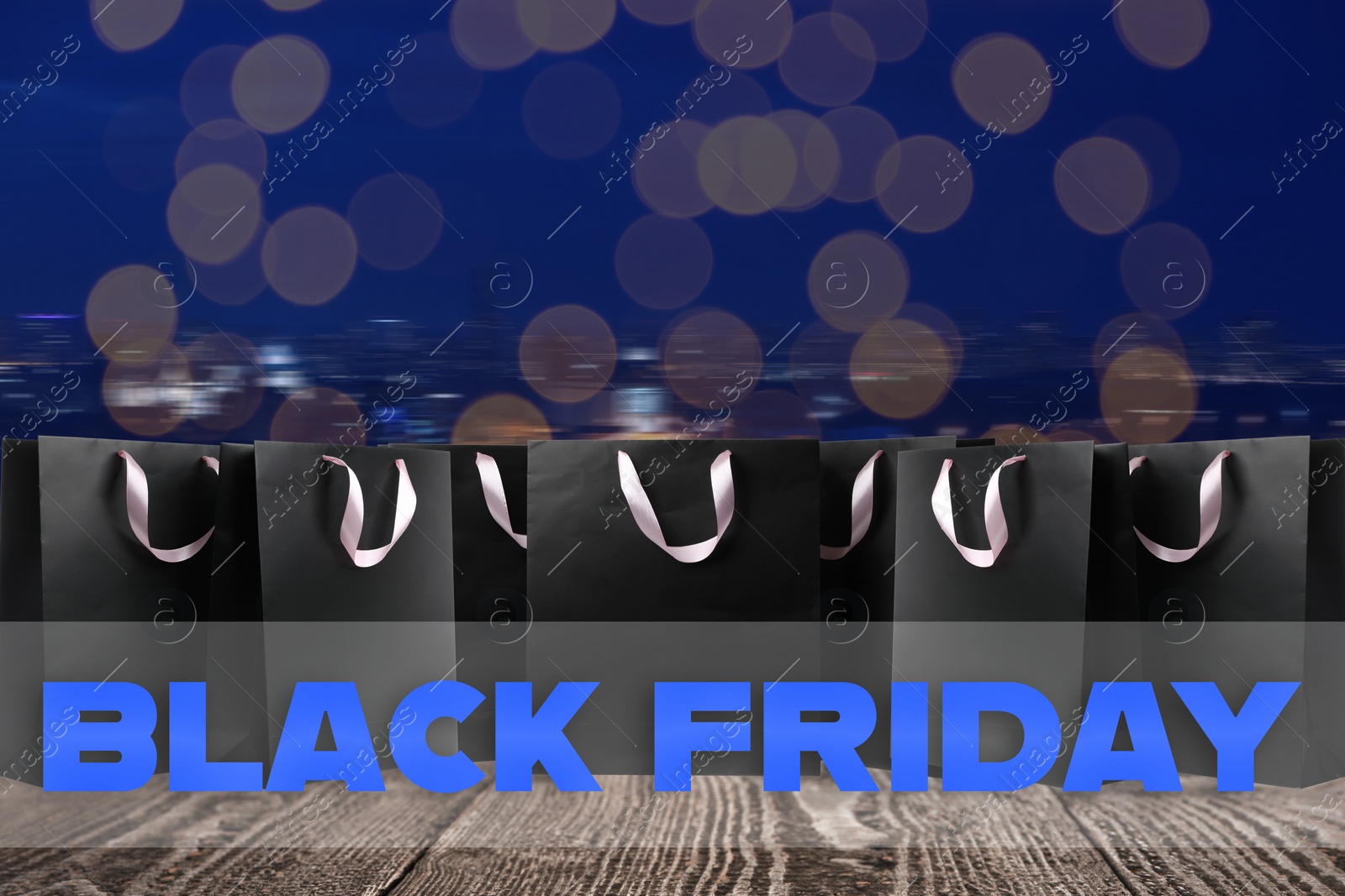 Image of Black Friday. Many shopping bags on wooden surface