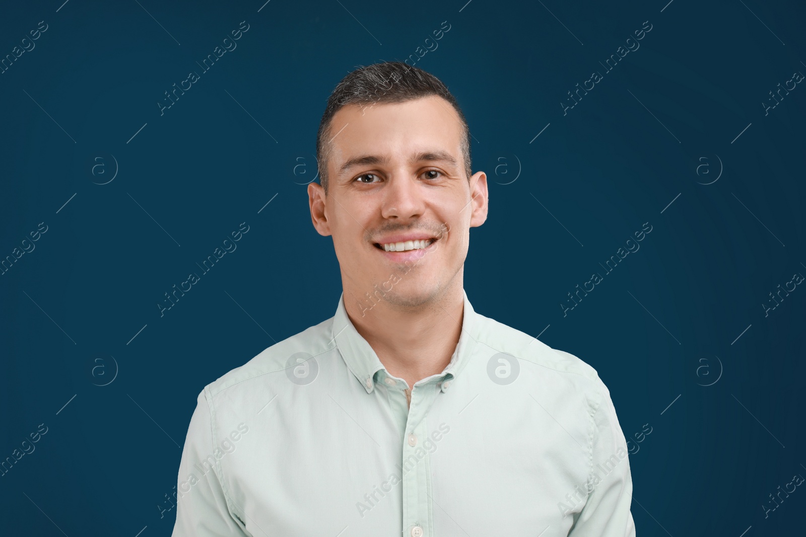 Photo of Portrait of handsome man on blue background