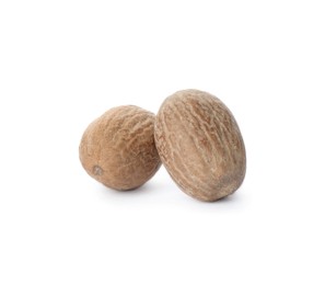 Photo of Two whole nutmeg seeds isolated on white