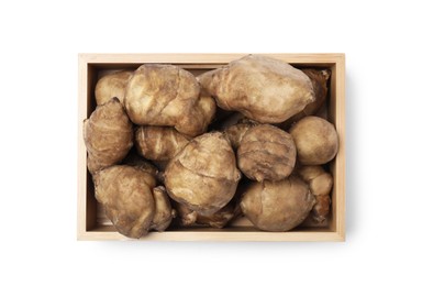 Photo of Wooden crate with fresh Jerusalem artichokes isolated on white, top view