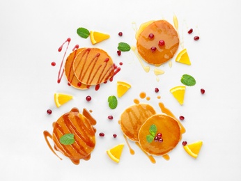 Photo of Delicious pancakes with fruits and jam on white background