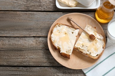 Photo of Slices of bread with butter, honey and milk on wooden table, flat lay. Space for text