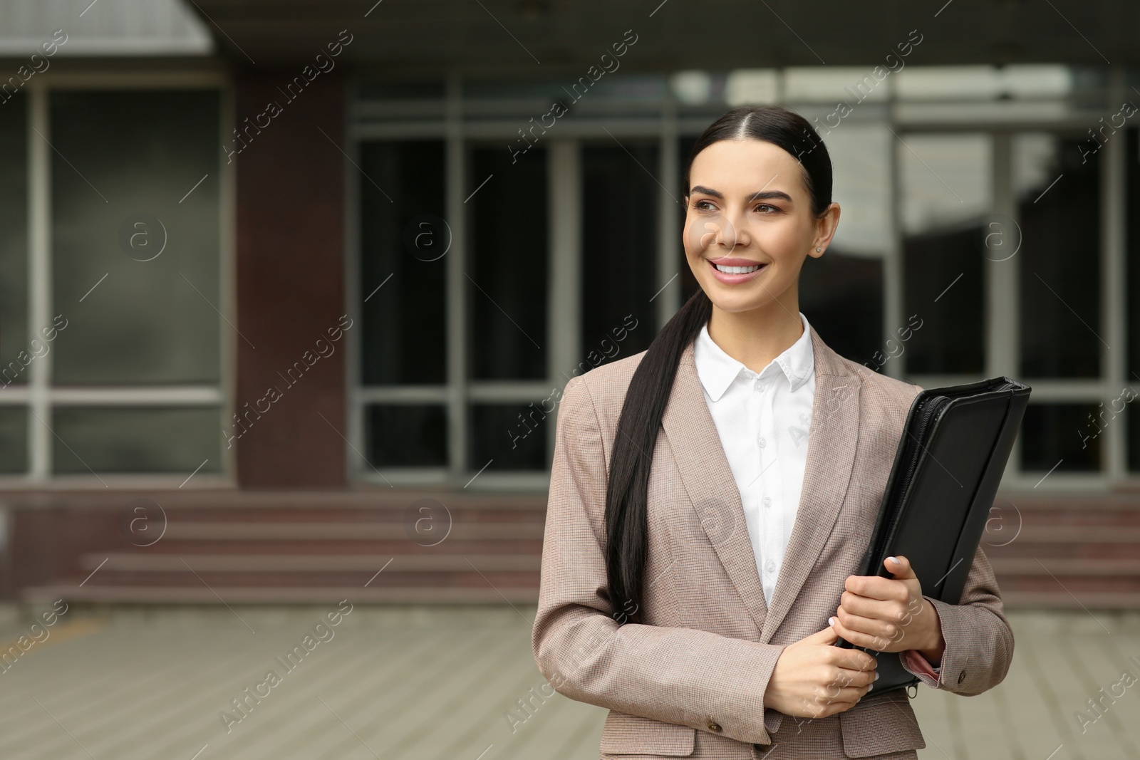 Photo of Beautiful real estate agent with documents outdoors, space for text