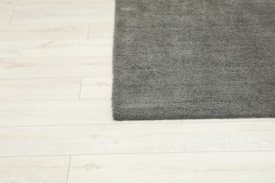 Photo of Soft grey carpet on white laminated floor indoors, top view. Space for text