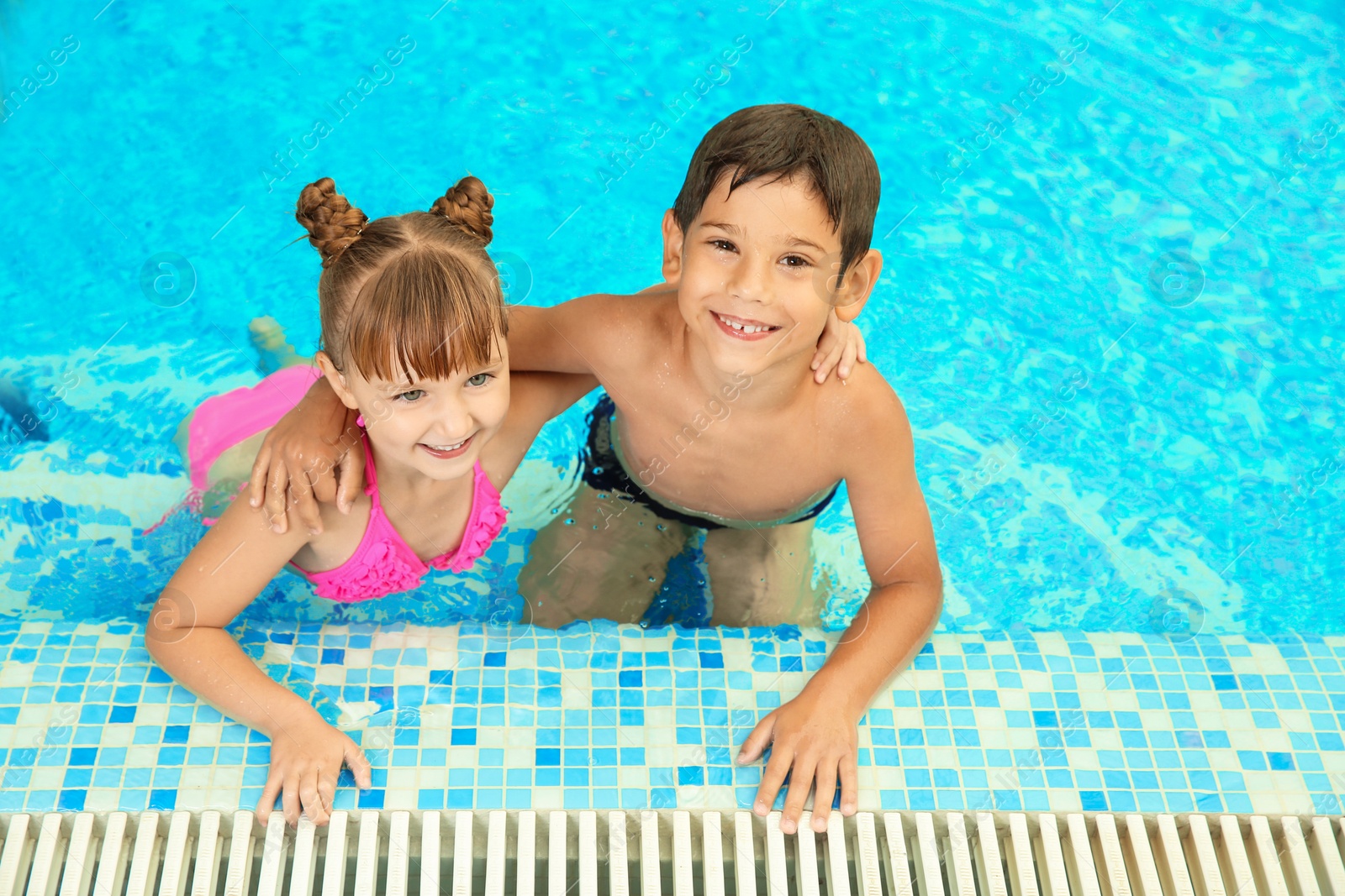 Photo of Happy children resting together in swimming pool