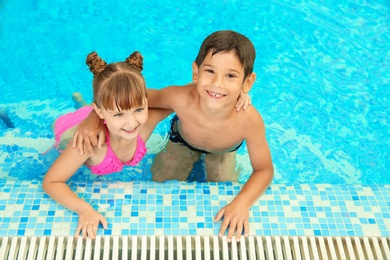 Happy children resting together in swimming pool