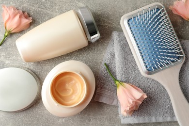 Photo of Flat lay composition with hair care cosmetic products on light grey table
