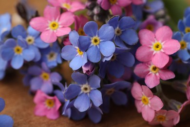 Photo of Beautiful fresh Forget-me-not flowers on table, closeup