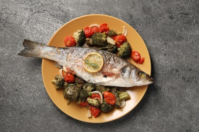 Photo of Delicious baked fish and vegetables on grey background, top view