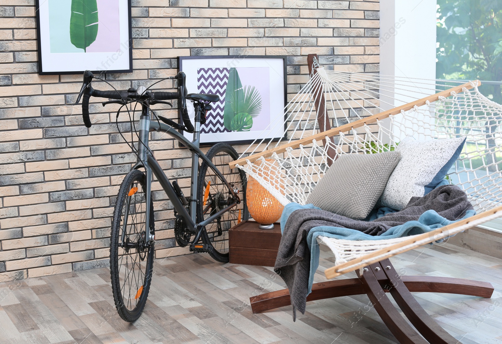 Photo of Modern bicycle and hammock in stylish room interior