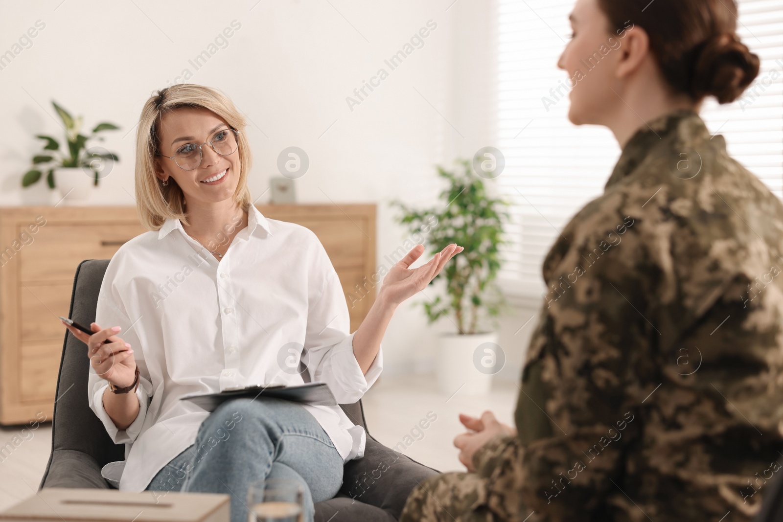 Photo of Psychotherapist working with military woman in office