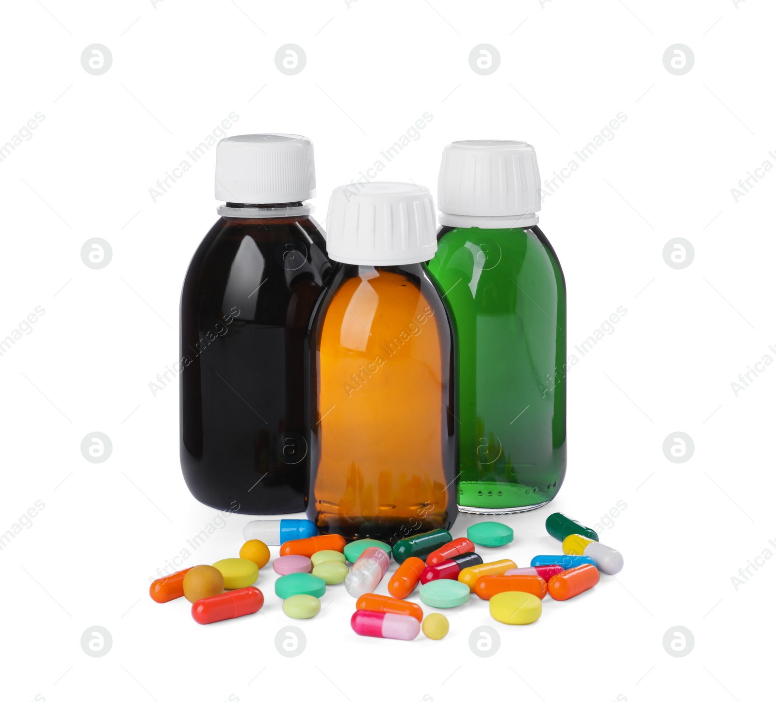 Photo of Bottles of syrups with pills on white background. Cough and cold medicine