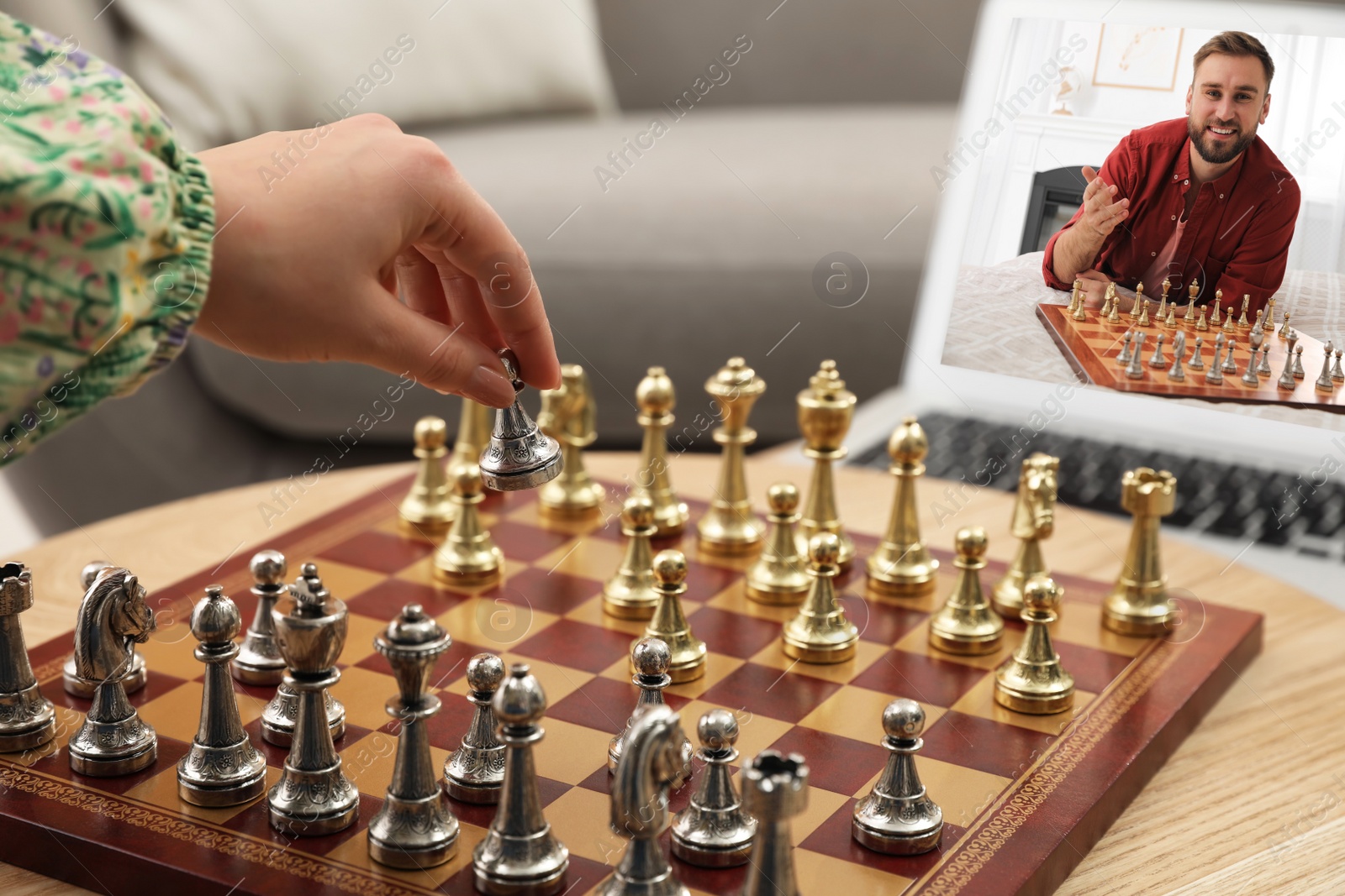 Image of Woman playing chess with partner via online video chat at home, closeup