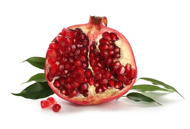 Ripe pomegranate with leaves on white background