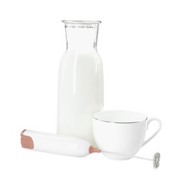 Photo of Milk frother wand, cup and glass carafe isolated on white