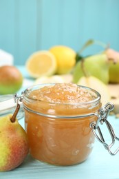 Photo of Tasty homemade pear jam and fresh fruits on light blue wooden table