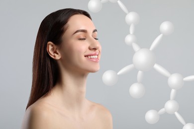 Image of Beautiful woman with perfect healthy skin and molecular model on grey background. Innovative cosmetology