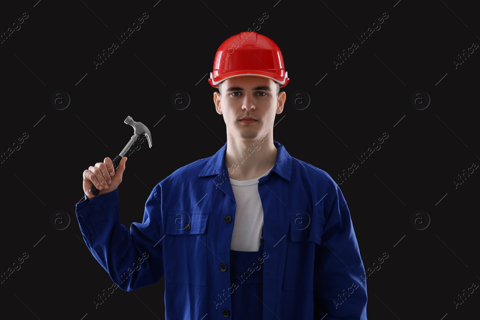 Photo of Professional repairman holding hammer on black background