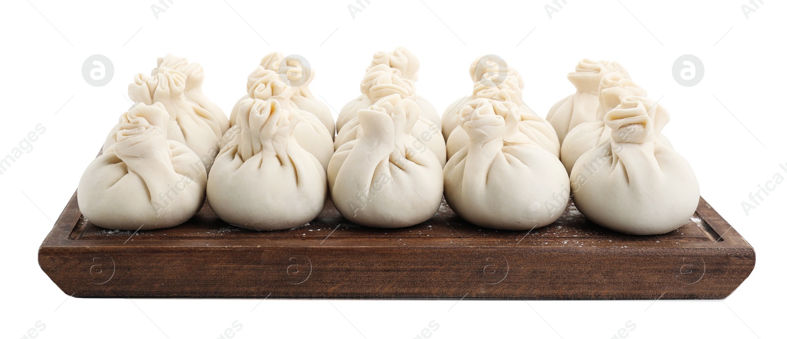 Photo of Wooden board with uncooked khinkali (dumplings) isolated on white. Georgian cuisine