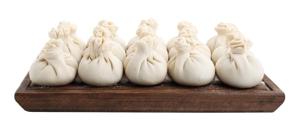 Wooden board with uncooked khinkali (dumplings) isolated on white. Georgian cuisine
