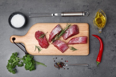 Photo of Flat lay composition with raw meat on grey background