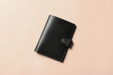 Photo of Stylish wallet on color background, top view