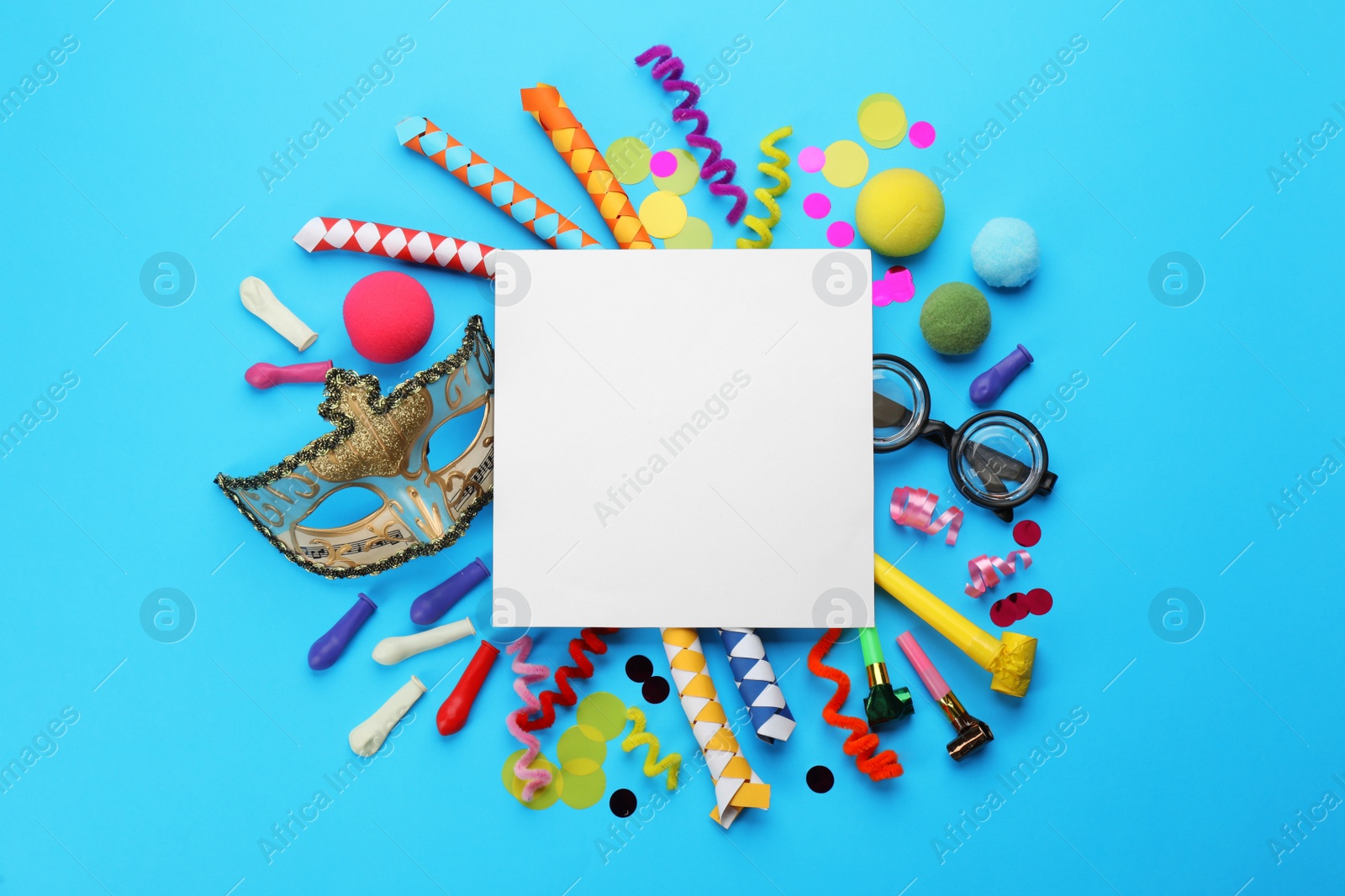 Photo of Flat lay composition with carnival items and blank card on light blue background. Space for text