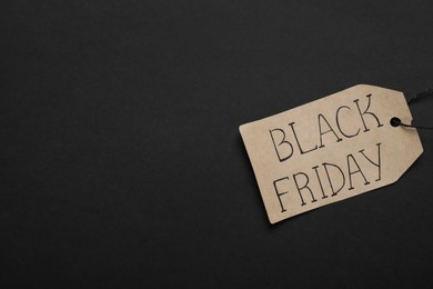 Black Friday tag on color background, top view. Space for text