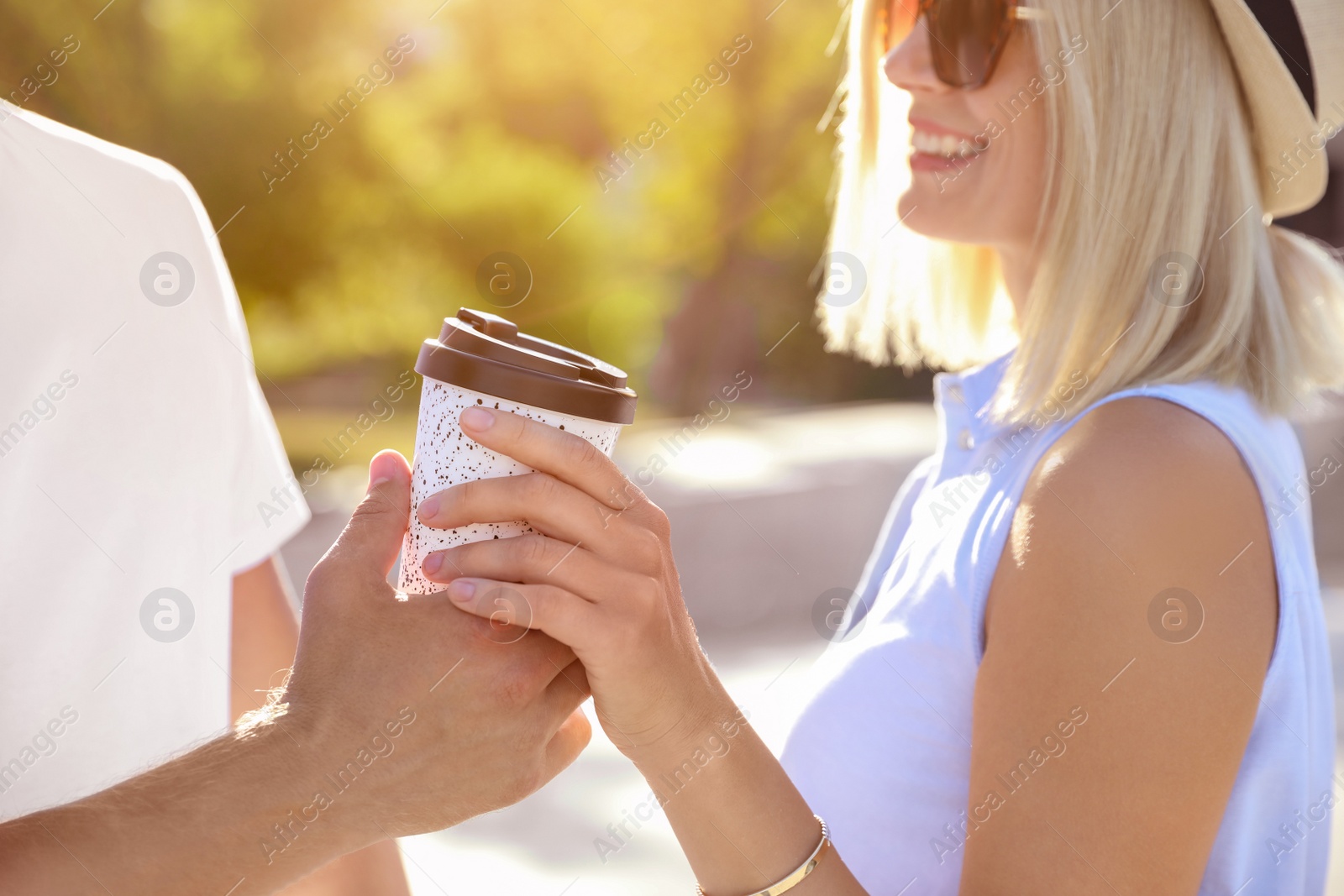 Photo of Couple with drink outdoors on summer day, closeup