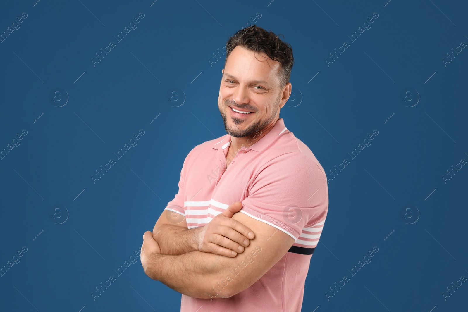 Photo of Portrait of handsome man on dark blue background