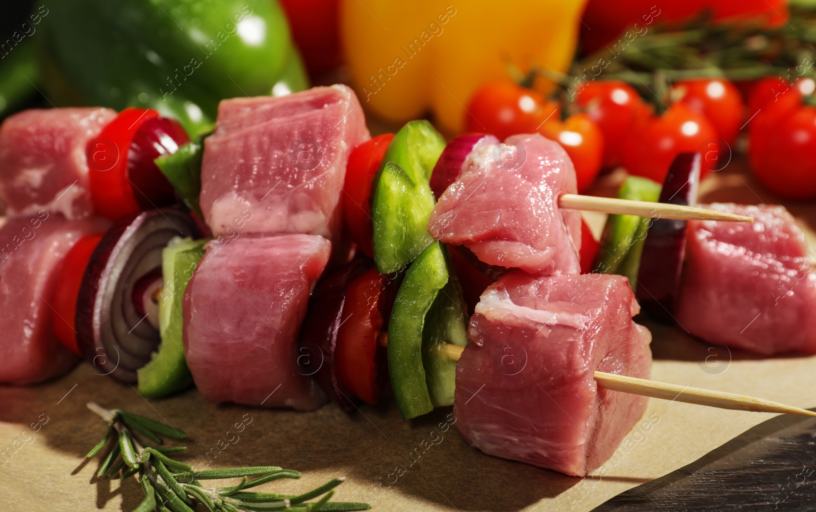 Photo of Skewers with fresh raw meat and vegetables on table, closeup