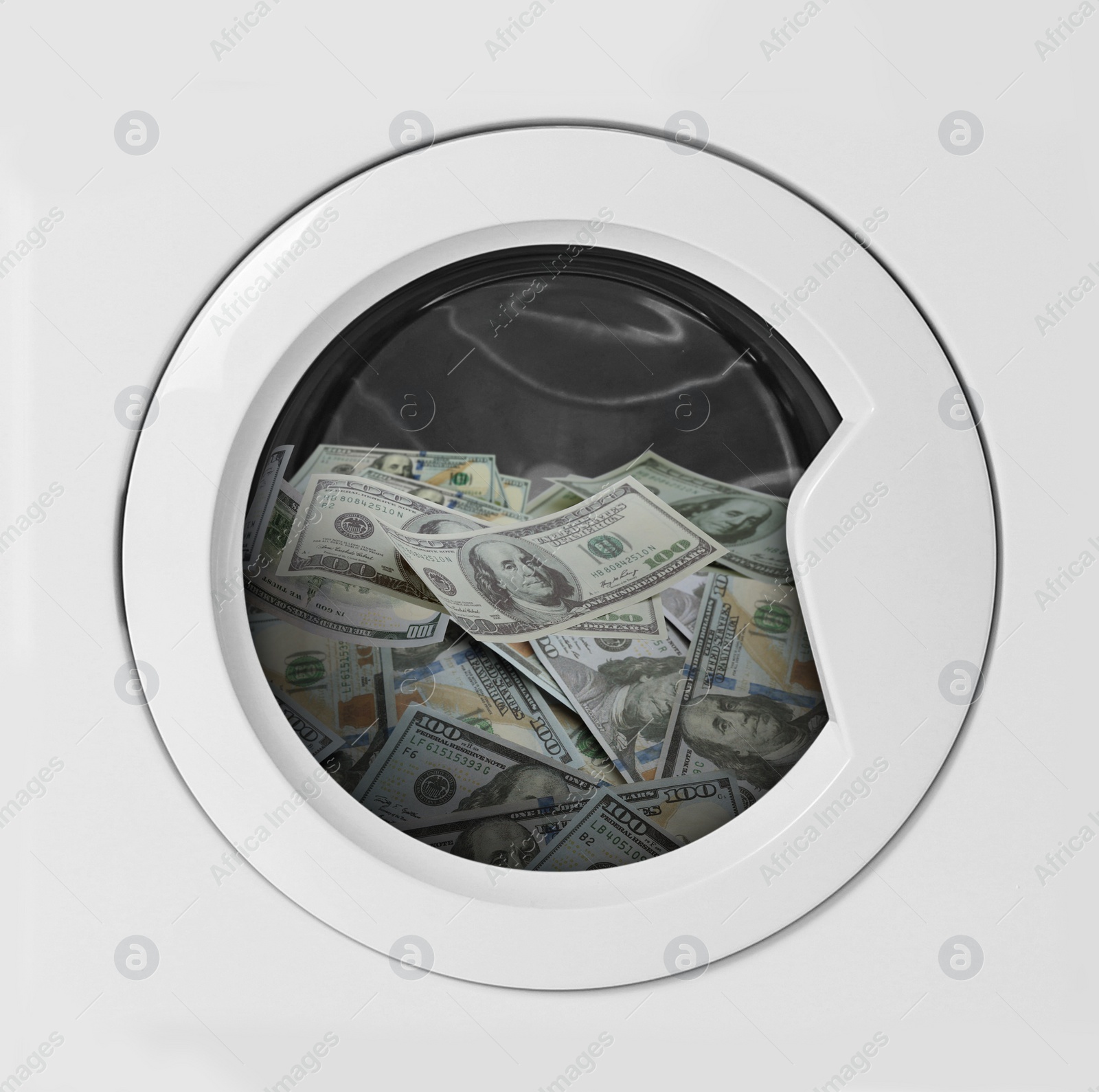 Image of Money laundering. Many dollar banknotes in washing machine