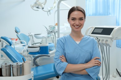 Portrait of professional dentist at workplace in clinic