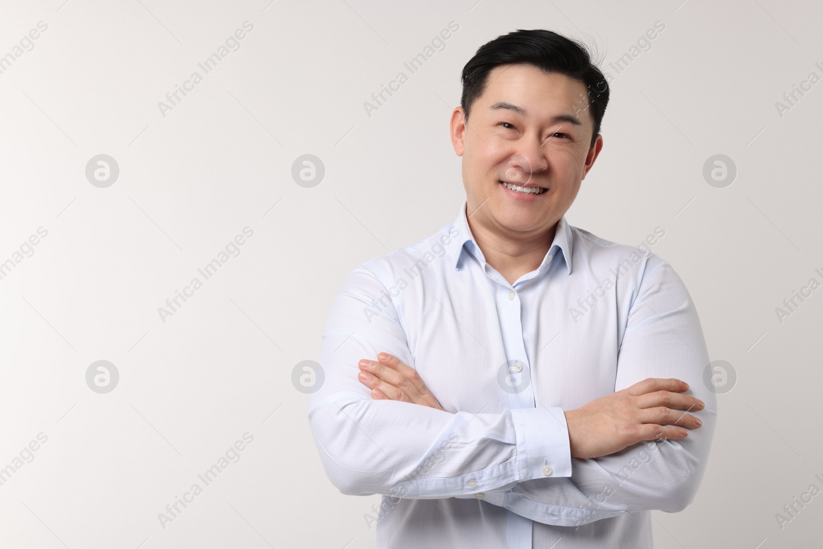 Photo of Portrait of happy man on light background. Space for text