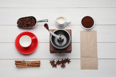 Flat lay composition with vintage manual coffee grinder and spices on white wooden background