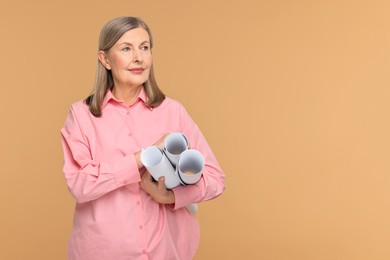 Photo of Architect with drafts on beige background, space for text