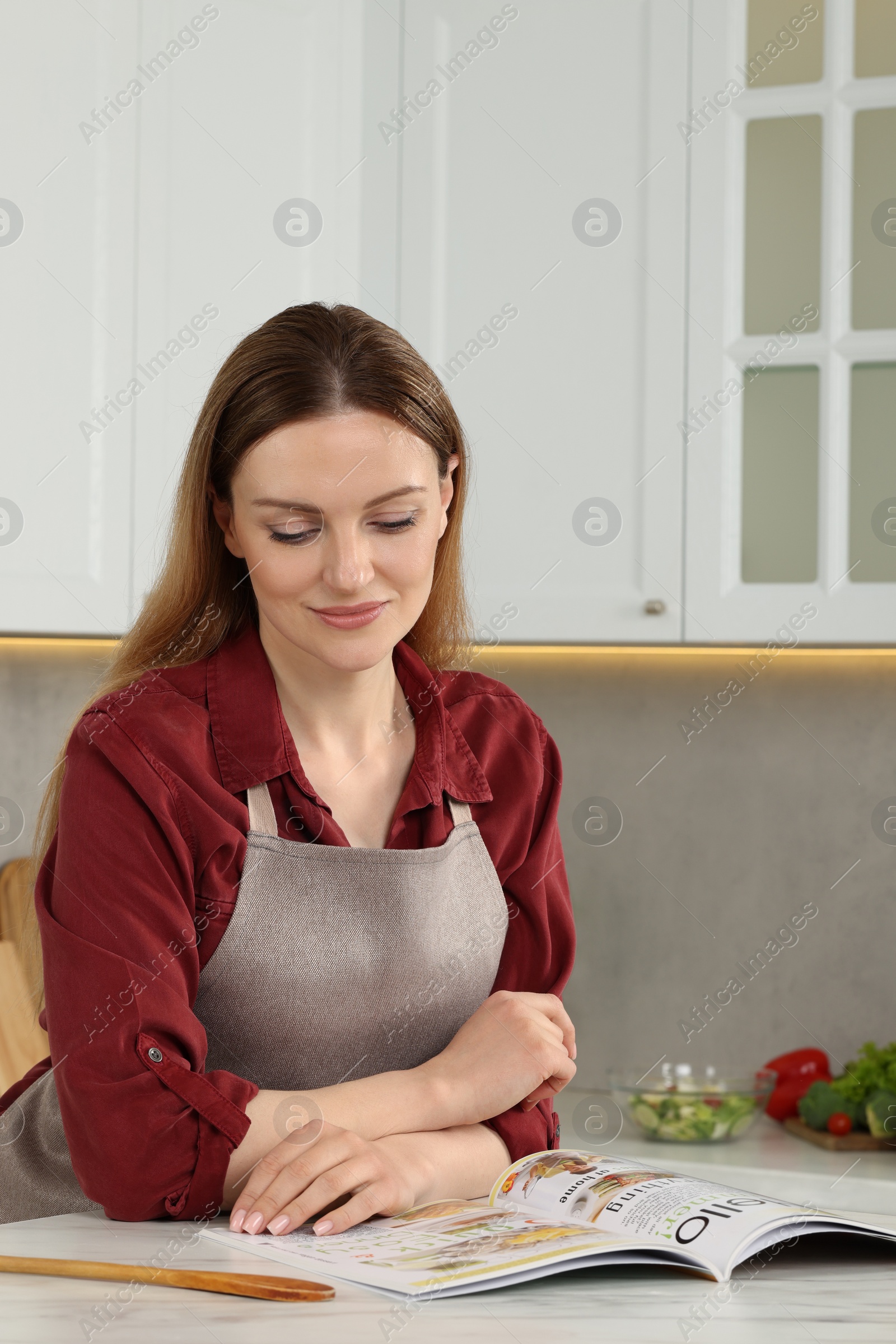 Photo of Woman reading recipe in culinary magazine at home, space for text