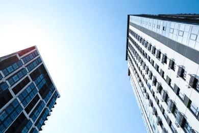 Low angle view of modern buildings on sunny day