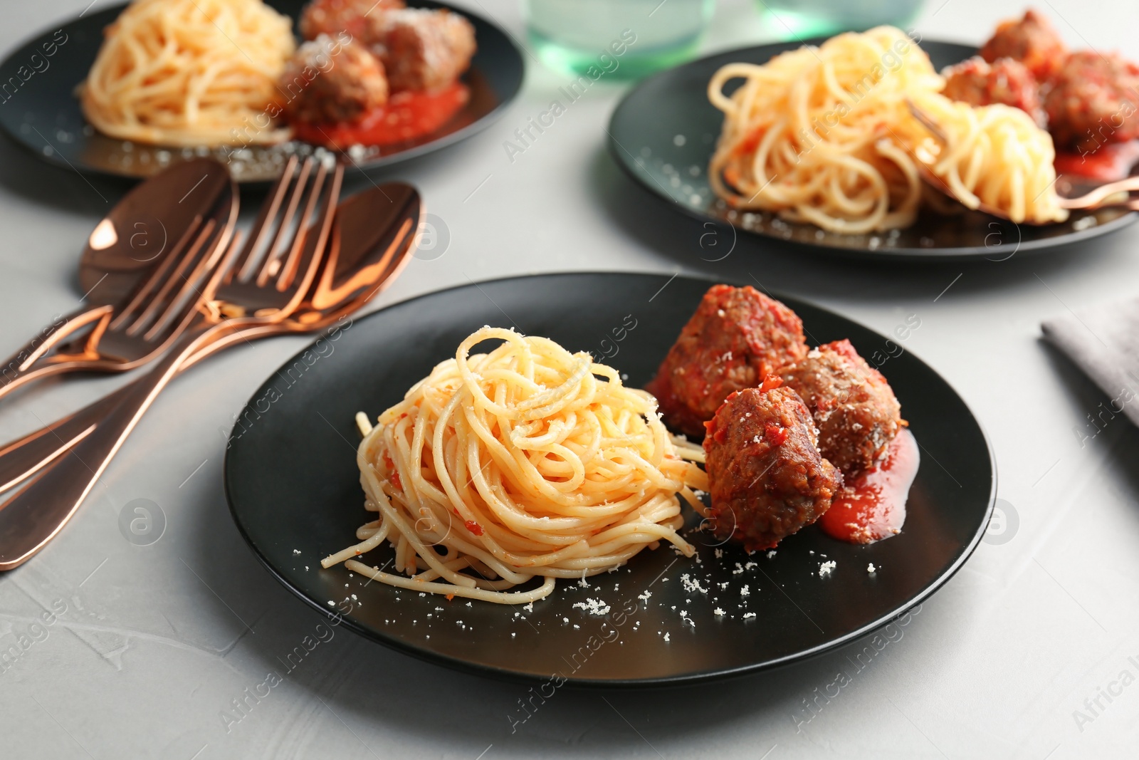 Photo of Delicious pasta with meatballs and tomato sauce on table