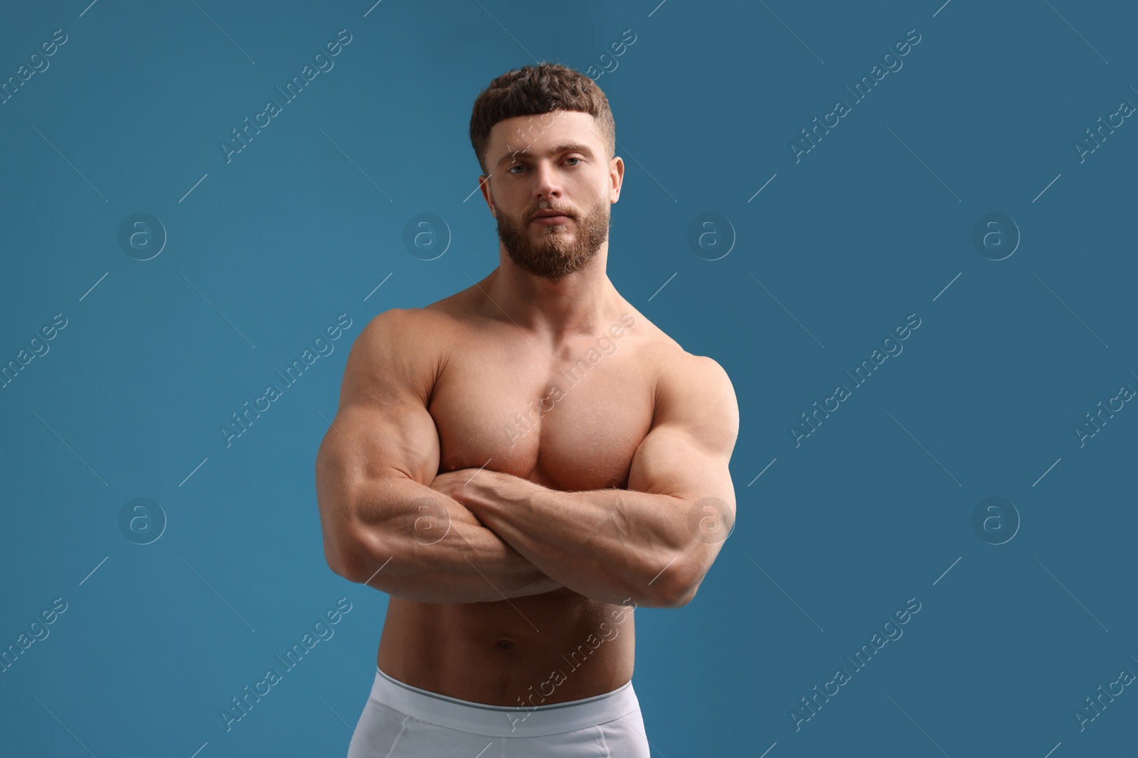 Photo of Handsome muscular man on light blue background. Sexy body