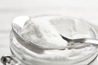 Photo of Jar and spoon with baking soda, closeup