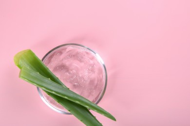 Photo of Aloe vera leaves and cosmetic gel on pink background, top view. Space for text