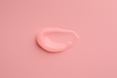 Sample of cosmetic gel on pink background, top view