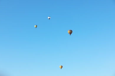 Photo of Colorful hot air balloons flying in blue sky
