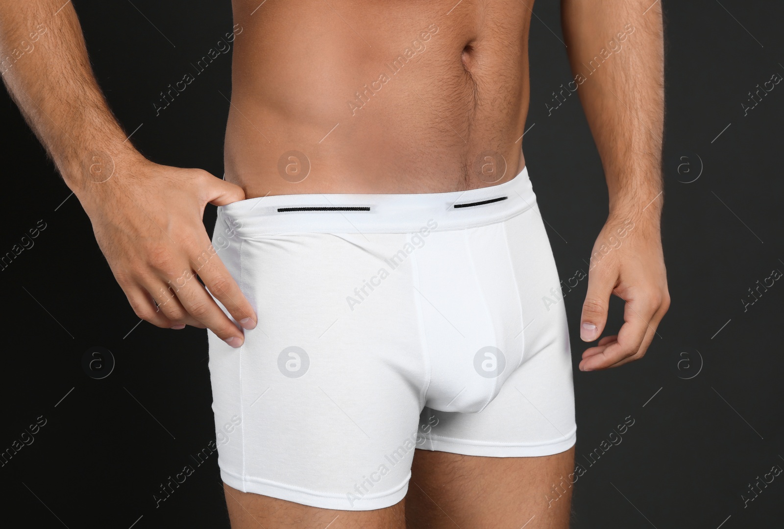 Photo of Man in underwear on black background, closeup