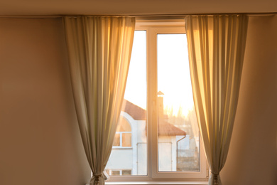 Window with beautiful beige curtains. Room decoration