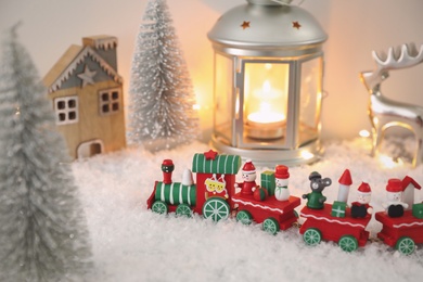 Toy train and Christmas decor on snow